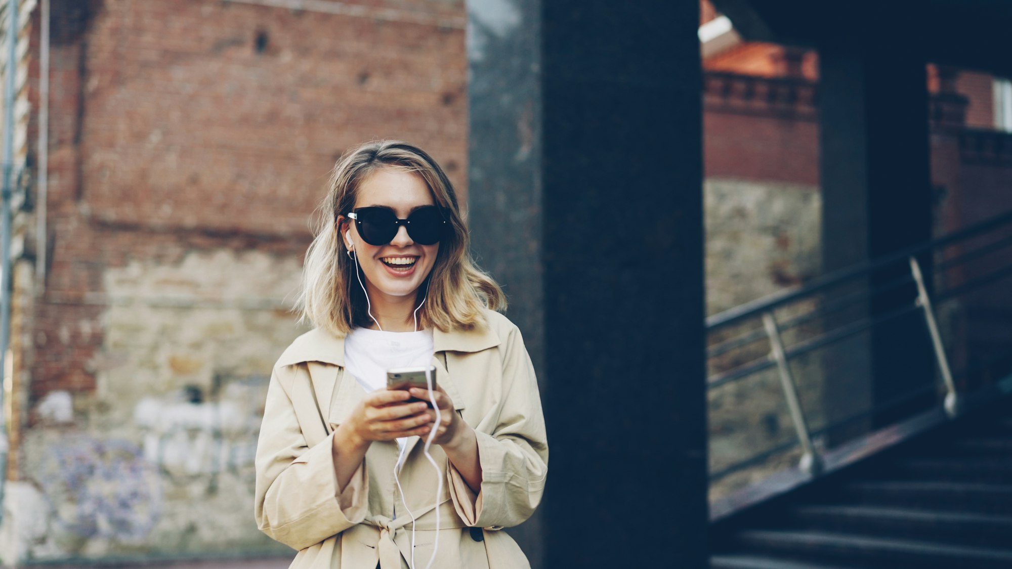 Smiling traveler using her smartphone abroad